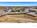 Aerial view of a developing neighborhood with homes surrounding open land at 2682 Southwind Rd, Berthoud, CO 80513