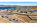 Aerial view of a vacant lot marked with red outline surrounded by a developing neighborhood at 2682 Southwind Rd, Berthoud, CO 80513