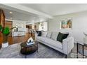 Bright and open living area with hardwood floors flowing into the dining and kitchen at 285 Holbrook St, Erie, CO 80516