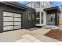 Close up of a contemporary home featuring a black brick garage, light siding, and minimalist landscaping at 2860 Table Mesa Dr, Boulder, CO 80305
