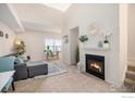Bright living room with a fireplace, gray sectional, and view to a window at 3235 S Walden Ct # E, Aurora, CO 80013