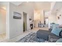 Cozy living room with a fireplace, gray sectional, and neutral decor at 3235 S Walden Ct # E, Aurora, CO 80013
