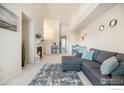 Inviting living room with a gray sectional sofa, neutral carpet, and fireplace at 3235 S Walden Ct # E, Aurora, CO 80013