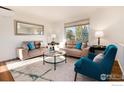 Bright living room featuring neutral furniture, modern decor, and natural light at 4547 Ashfield Dr, Boulder, CO 80301