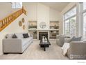 Bright living room with fireplace, built-in shelving, large windows and cozy seating at 4575 Maple Ct, Boulder, CO 80301