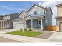 Two story home featuring a cozy front porch and an attached two car garage at 5453 Bauer Dr, Frederick, CO 80504