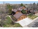 Aerial view of townhomes with three-car garages, mature trees, and green lawns at 6251 Willow Ln, Boulder, CO 80301