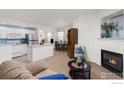 Open-concept living area with a fireplace, kitchen with stainless steel appliances, and dining area at 640 Gooseberry Dr # 1103, Longmont, CO 80503