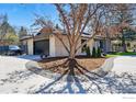 Circular driveway leads to a modern home with well-maintained landscaping and an attached garage at 6923 Hunter Pl, Boulder, CO 80301