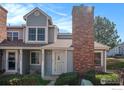 Charming townhome featuring a brick chimney, fresh paint, and well-maintained landscaping at 8265 W 90Th Pl, Westminster, CO 80021