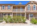 Townhome exterior showcasing a cozy balcony and well-maintained landscaping at 104 Pheasant Run, Louisville, CO 80027