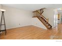 Inviting living room with hardwood floors and a staircase at 104 Pheasant Run, Louisville, CO 80027