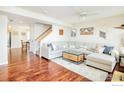 Spacious living area with hardwood floors, open staircase, and comfortable sectional sofa at 1065 Laramie Blvd # F, Boulder, CO 80304