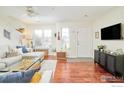 Sunlit living room with wood floors, modern furniture, and a view of the front door at 1065 Laramie Blvd # F, Boulder, CO 80304