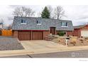 Charming two-story brick home featuring an oversized roof, mature trees, and an attached two-car garage at 10679 Union Way, Broomfield, CO 80021