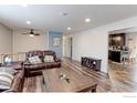 Spacious living room featuring hardwood floors, recessed lighting, comfortable couches, and open floor plan at 10679 Union Way, Broomfield, CO 80021