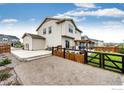 A backyard with a concrete patio and pergola for outdoor entertaining and a fenced yard at 1191 Horsetail Loop, Elizabeth, CO 80107