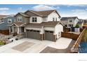 This charming two-story home features a three-car garage, inviting front porch and well-maintained landscaping at 1191 Horsetail Loop, Elizabeth, CO 80107