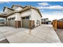 This spacious three-car garage features brick accents and a paved driveway at 1191 Horsetail Loop, Elizabeth, CO 80107