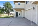 Charming home featuring a well-lit entrance, attached garage, and neat landscaping in a serene setting at 13122 Grant N Cir # B, Thornton, CO 80241