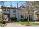 Exterior showcasing a long driveway and a beautifully landscaped front yard with mature trees at 1373 N Franklin St # 1, Denver, CO 80218