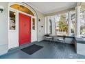 Charming red front door entrance to the home with seating area at 1373 N Franklin St # 1, Denver, CO 80218