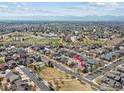 Expansive aerial view showcasing the neighborhood, the home's location, nearby green spaces, and mountain views at 1433 Moonlight Dr, Longmont, CO 80504