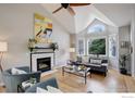 Bright living room boasts hardwood floors, fireplace, and vaulted ceiling at 1540 Sumac Ave, Boulder, CO 80304