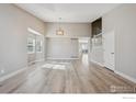 Spacious living room with vaulted ceilings, modern light fixture and staircase at 16457 Lafayette St, Thornton, CO 80602