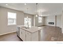 Spacious kitchen features granite countertops, a kitchen island, and stainless steel appliances at 1898 Westport Ave, Berthoud, CO 80513