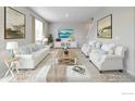 Bright living room with stylish decor, plush seating, and large windows, creating a comfortable and inviting atmosphere at 1898 Westport Ave, Berthoud, CO 80513