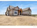 Well-built home featuring craftsman-style architecture, stone accents, and covered entry at 1920 Country Dr, Frederick, CO 80504