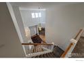 Bright foyer with high ceilings, hardwood floors, and a staircase leading to the upper level at 2000 Prestwick Ct, Longmont, CO 80504