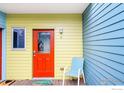 Charming front door with vibrant colors and a cozy welcome mat at 2018 Ionosphere St # 8, Longmont, CO 80504