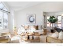 Bright living room with vaulted ceilings, large windows, neutral decor, and stylish furnishings at 221 S Lark Ave, Louisville, CO 80027