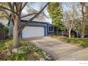 Single Gathering home featuring an attached two-car garage with a spacious driveway at 247 Regal St, Louisville, CO 80027