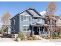 Side view of a two-story home, blue siding, gray accents, small well-maintained yard at 2879 Shadow Lake Rd, Lafayette, CO 80026