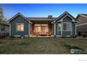 Spacious backyard showcasing a patio with comfortable seating, perfect for outdoor relaxation at 2882 Heron Lakes Pkwy, Berthoud, CO 80513