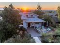 Aerial view of charming single-story home with landscaped yard, patio area, and stunning sunset backdrop at 2942 4Th St, Boulder, CO 80304