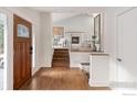 Bright foyer with hardwood floors and view into the living area with a fireplace and staircase at 2942 4Th St, Boulder, CO 80304