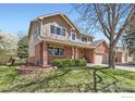 Charming two-story home with a brick and siding exterior and a well-maintained lawn at 3124 Marlin Dr, Longmont, CO 80503