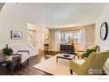 Bright living room with hardwood floors, neutral walls, and large windows at 3124 Marlin Dr, Longmont, CO 80503