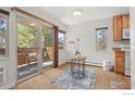 Dining nook with sliders to a deck with views of green trees at 3335 Chisholm Trl # 206, Boulder, CO 80301