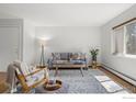Bright living room with large window, comfortable seating, and a stylish rug at 3335 Chisholm Trl # 206, Boulder, CO 80301