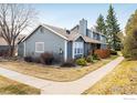 Exterior side view of home with well maintained lawn and garden at 3823 Paseo Del Prado, Boulder, CO 80301