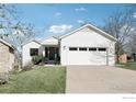 Inviting home exterior with a well-maintained lawn and attached garage, painted in a bright white color at 3962 Promontory Ct, Boulder, CO 80304