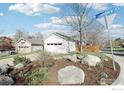 Charming home exterior displaying attractive rock landscaping with a two-car garage on a peaceful street at 3962 Promontory Ct, Boulder, CO 80304