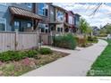 Street view of colorful townhomes with well-maintained landscaping and sidewalks at 4150 Longview Ln, Boulder, CO 80301
