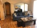 Comfortable living room featuring a blue sofa, marble coffee table, and stylish decor at 4500 Baseline Rd # 4104, Boulder, CO 80303
