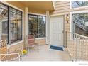 Charming front porch with seating area, creating a welcoming entrance to the home at 4725 Spine Rd # E, Boulder, CO 80301